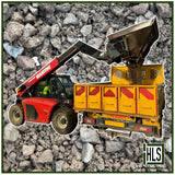HLSupplies red Manitou telehandler loading MOT Type 1 aggregate into a yellow transit truck.