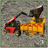 HLSupplies red Manitou telehandler loading sharp sand into a yellow truck bed. Bulk aggregate delivery.